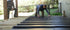 Two people installing UnderDeck Shields panels on the topside of a deck.